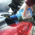 Fuel additive being poured into a cars fuel tank