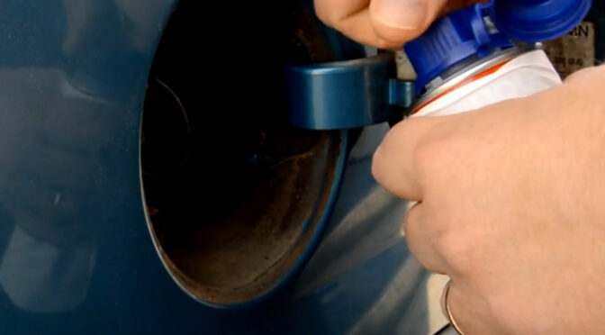 Fuel additive about to be added to a vehicles fuel tank.