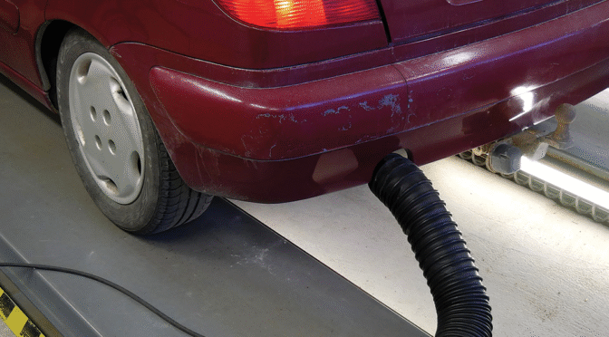 Car with equipment attached to the exhaust