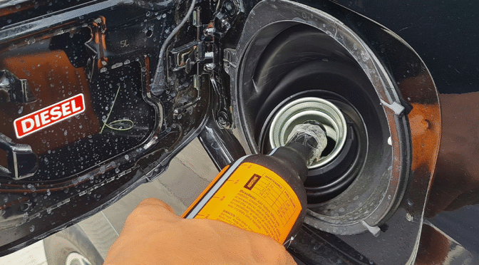 A fuel additive being poured into a vehicle.