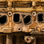 the side of an engine block showing carbon on the internals