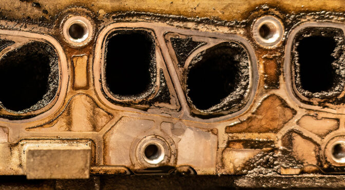 the side of an engine block showing carbon on the internals
